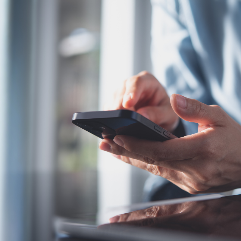 Hand scrolling on mobile phone.